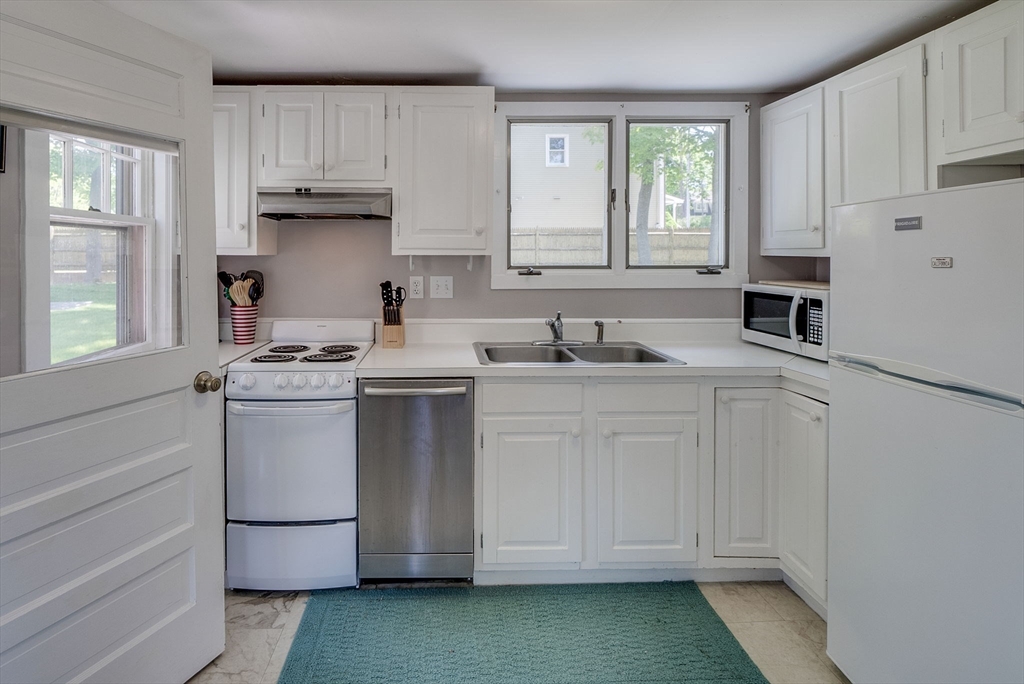 18 Smith Road Rockport, MA 01966 - Photo 11 of 28 a kitchen with white cabinets and white appliances