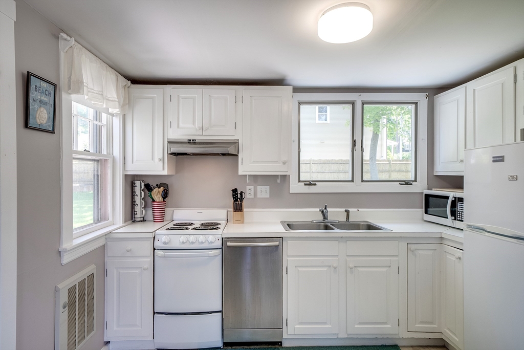 18 Smith Road Rockport, MA 01966 - Photo 12 of 28 a kitchen with white cabinets and white appliances