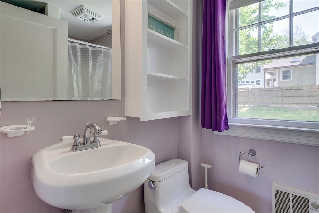 18 Smith Road Rockport, MA 01966 - Photo 14 of 28 a bathroom with a sink a toilet and mirror