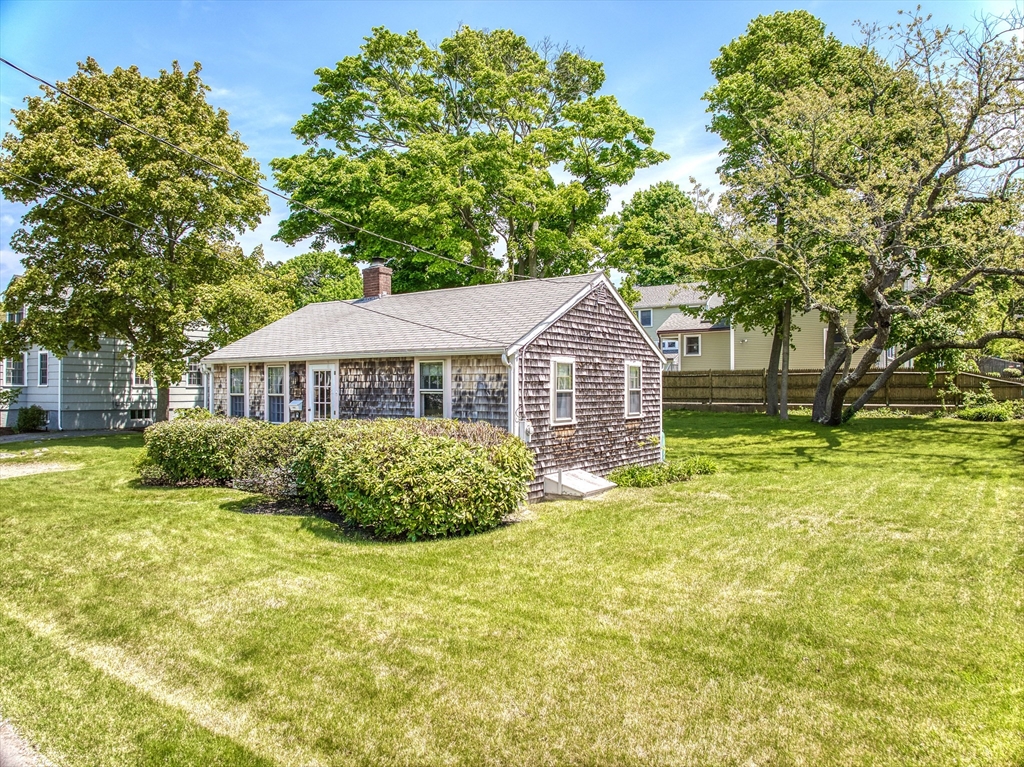 18 Smith Road Rockport, MA 01966 - Photo 4 of 28 a front view of a house with a garden