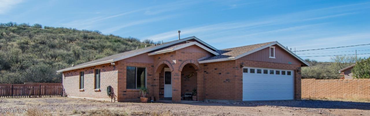 1399 Via Patricia Rio Rico, AZ 85648 - Photo 1 of 9 a front view of a house with a yard and garage