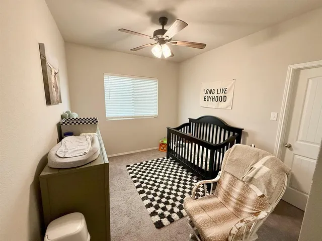 a bedroom with a bed and a chair