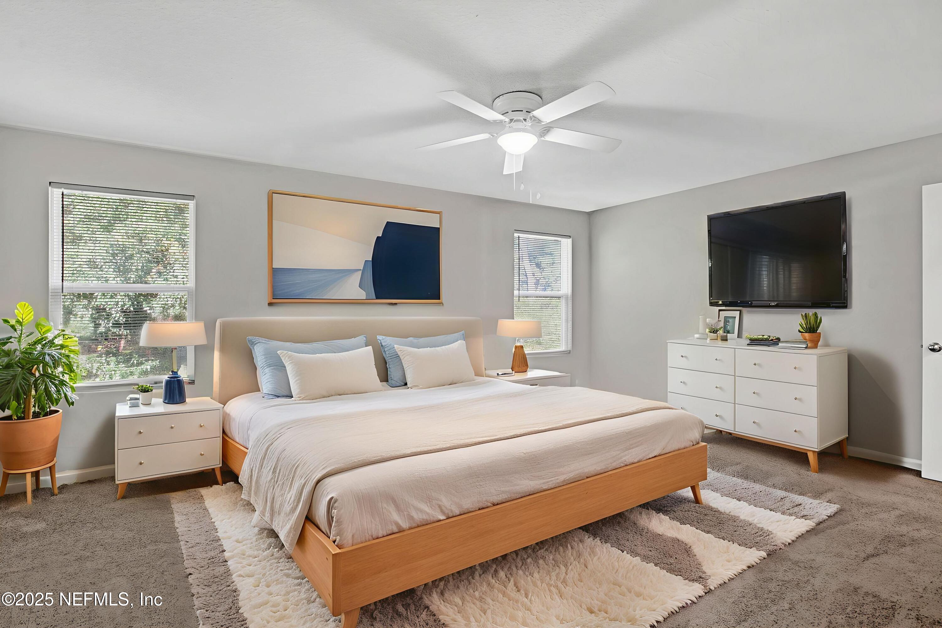 10632 Tulsa Road Jacksonville, FL 32218 - Photo 11 of 25 a bedroom with a bed and a flat screen tv