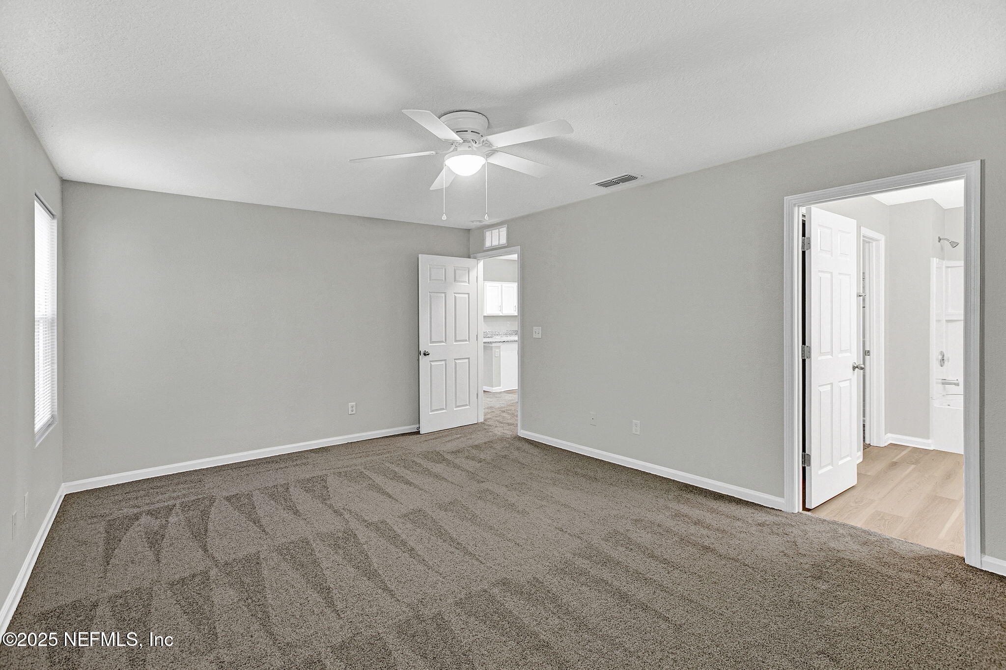 10632 Tulsa Road Jacksonville, FL 32218 - Photo 13 of 25 wooden floor in an empty room with a window