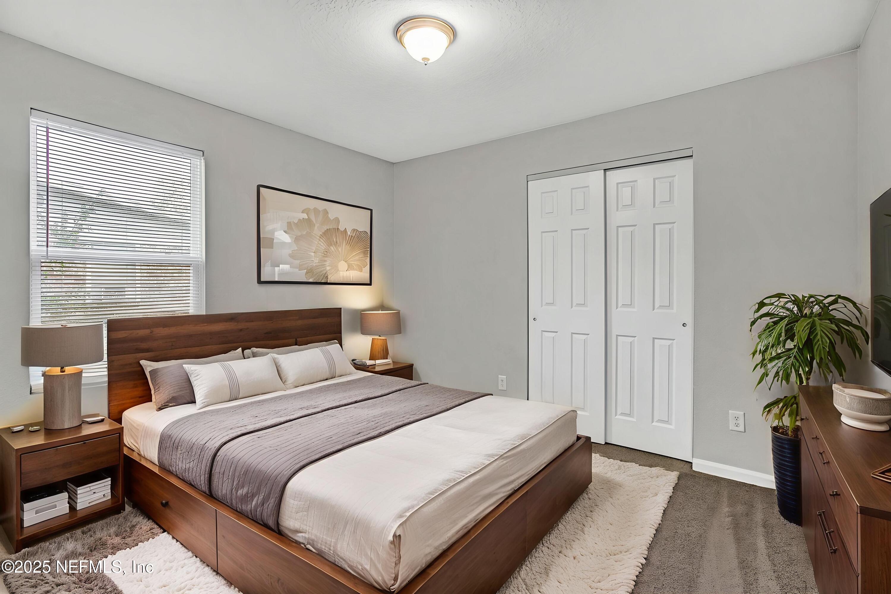 10632 Tulsa Road Jacksonville, FL 32218 - Photo 17 of 25 a bedroom with bed and a potted plant