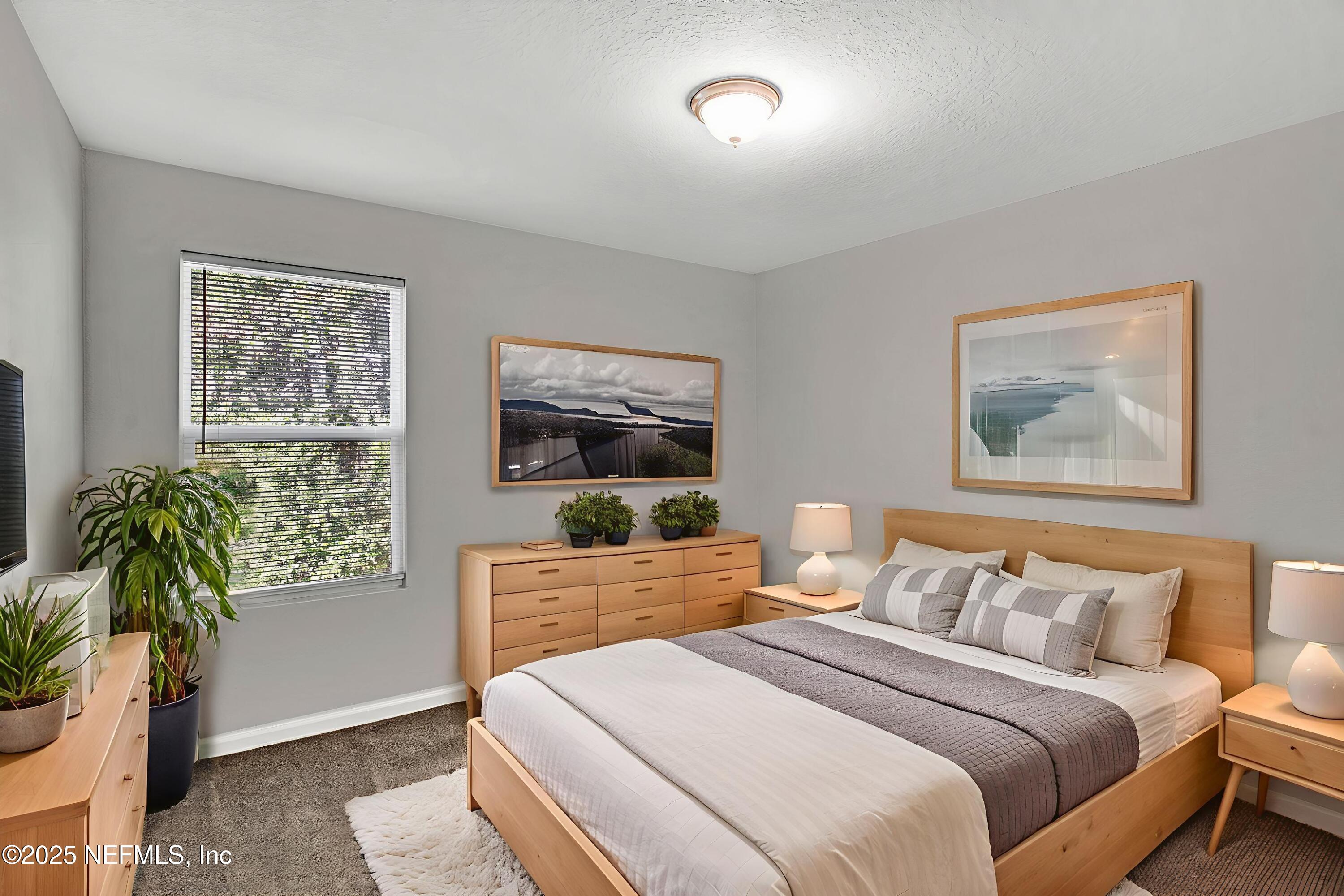 10632 Tulsa Road Jacksonville, FL 32218 - Photo 19 of 25 a bedroom with a bed and a painting on the wall