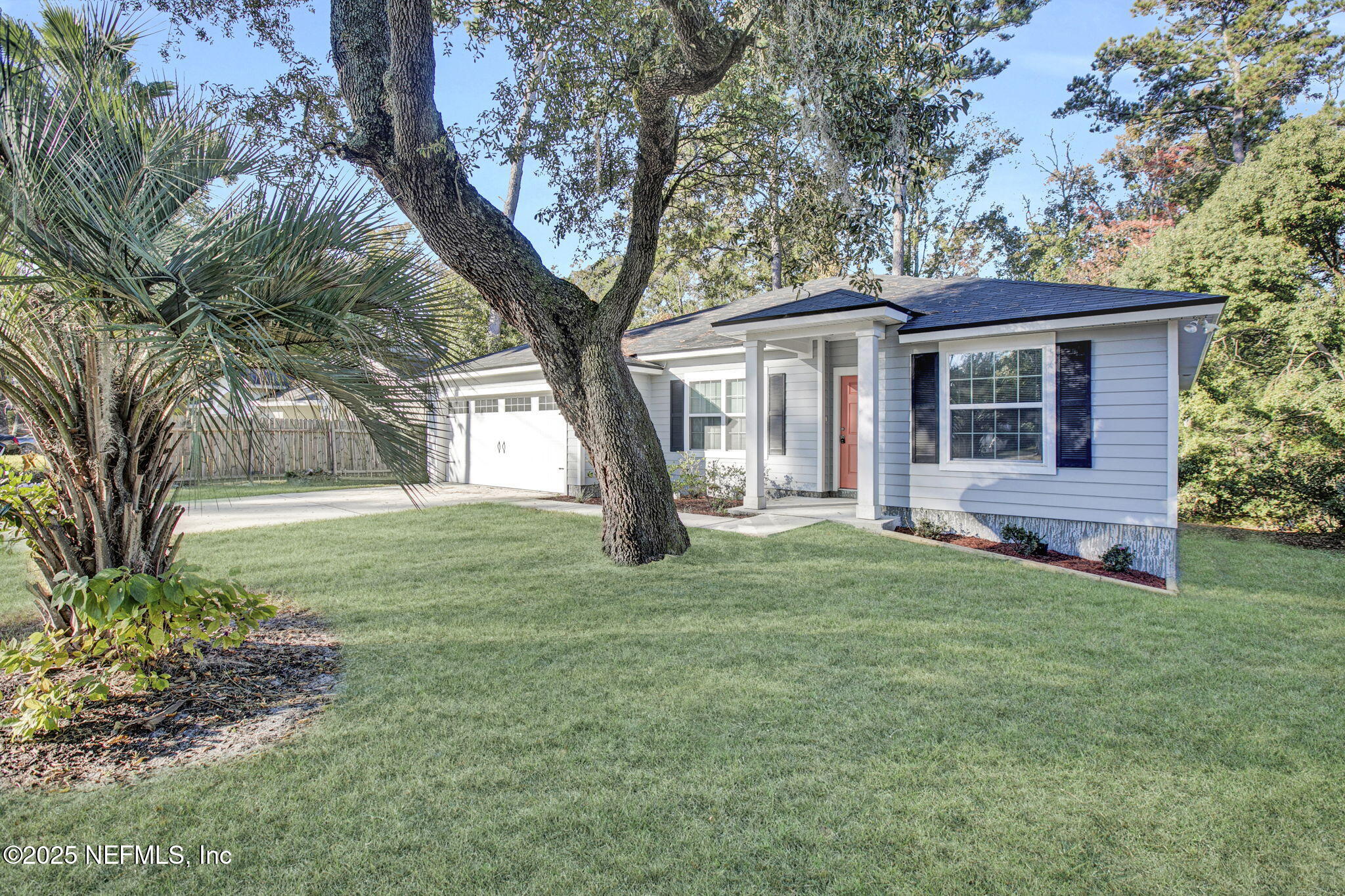 10632 Tulsa Road Jacksonville, FL 32218 - Photo 2 of 25 a tree in front of a white house