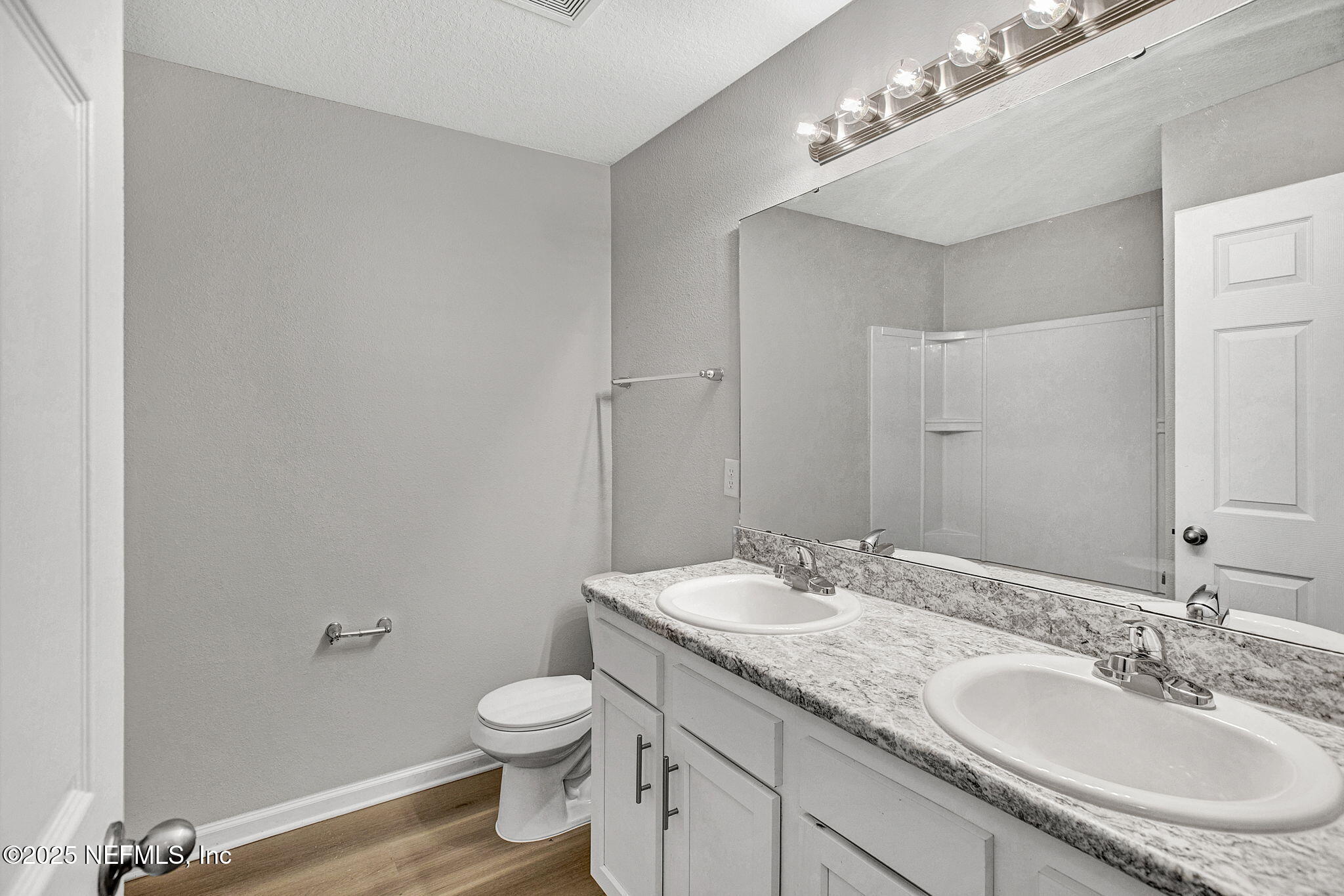 10632 Tulsa Road Jacksonville, FL 32218 - Photo 21 of 25 a bathroom with a granite countertop sink a toilet and a mirror