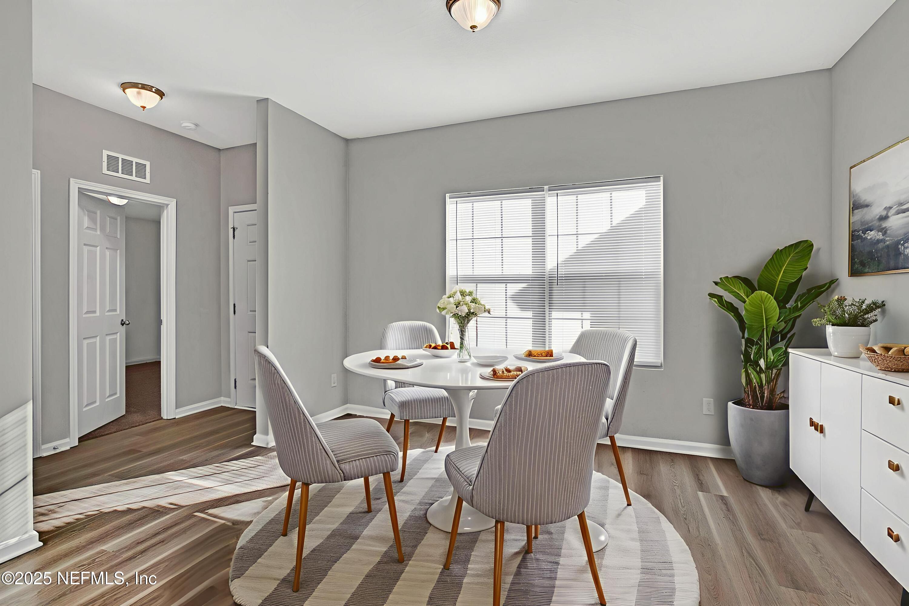 10632 Tulsa Road Jacksonville, FL 32218 - Photo 4 of 25 a view of a dining room with furniture window and wooden floor
