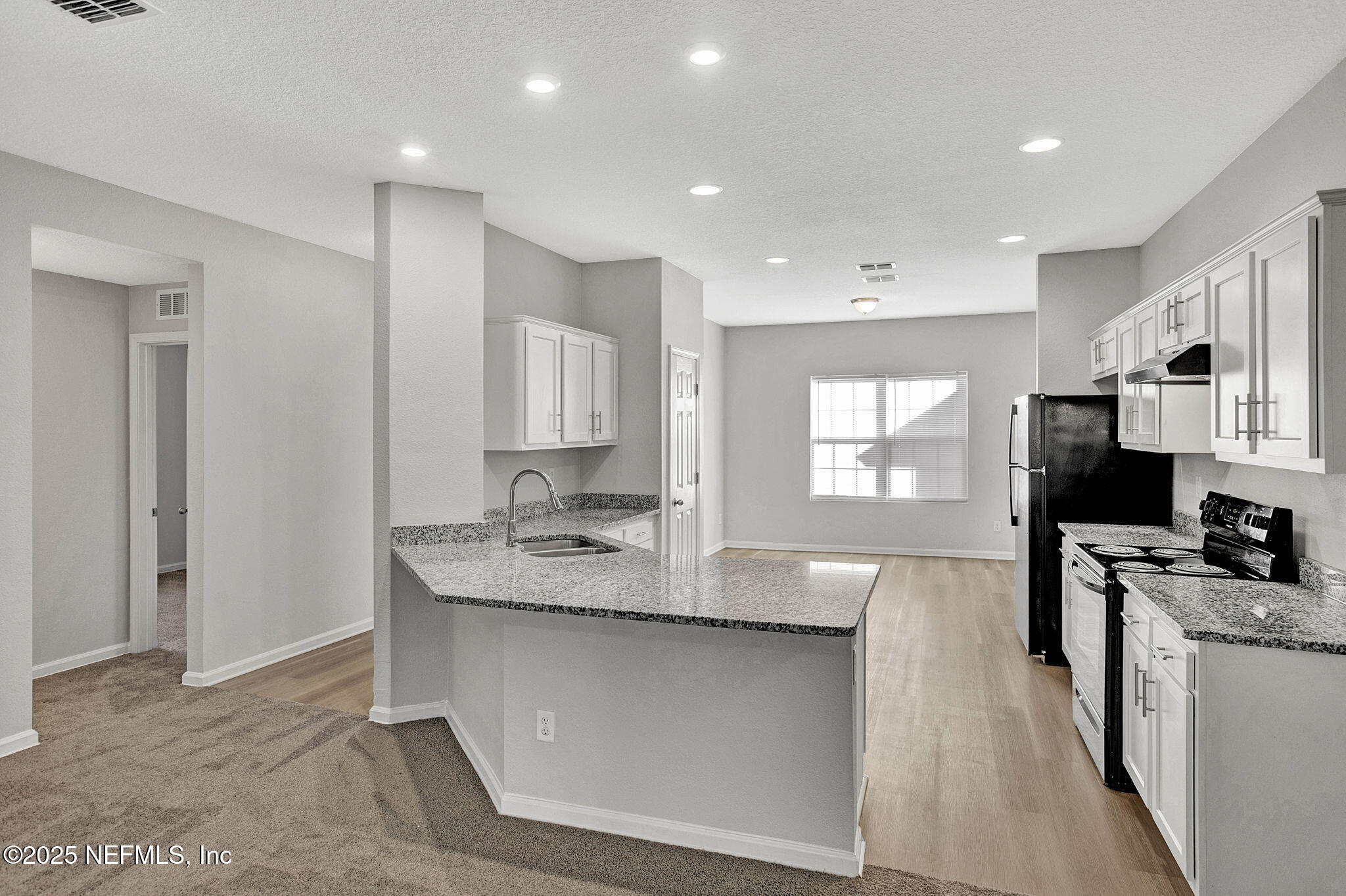 10632 Tulsa Road Jacksonville, FL 32218 - Photo 5 of 25 a kitchen with stainless steel appliances granite countertop a sink stove and refrigerator