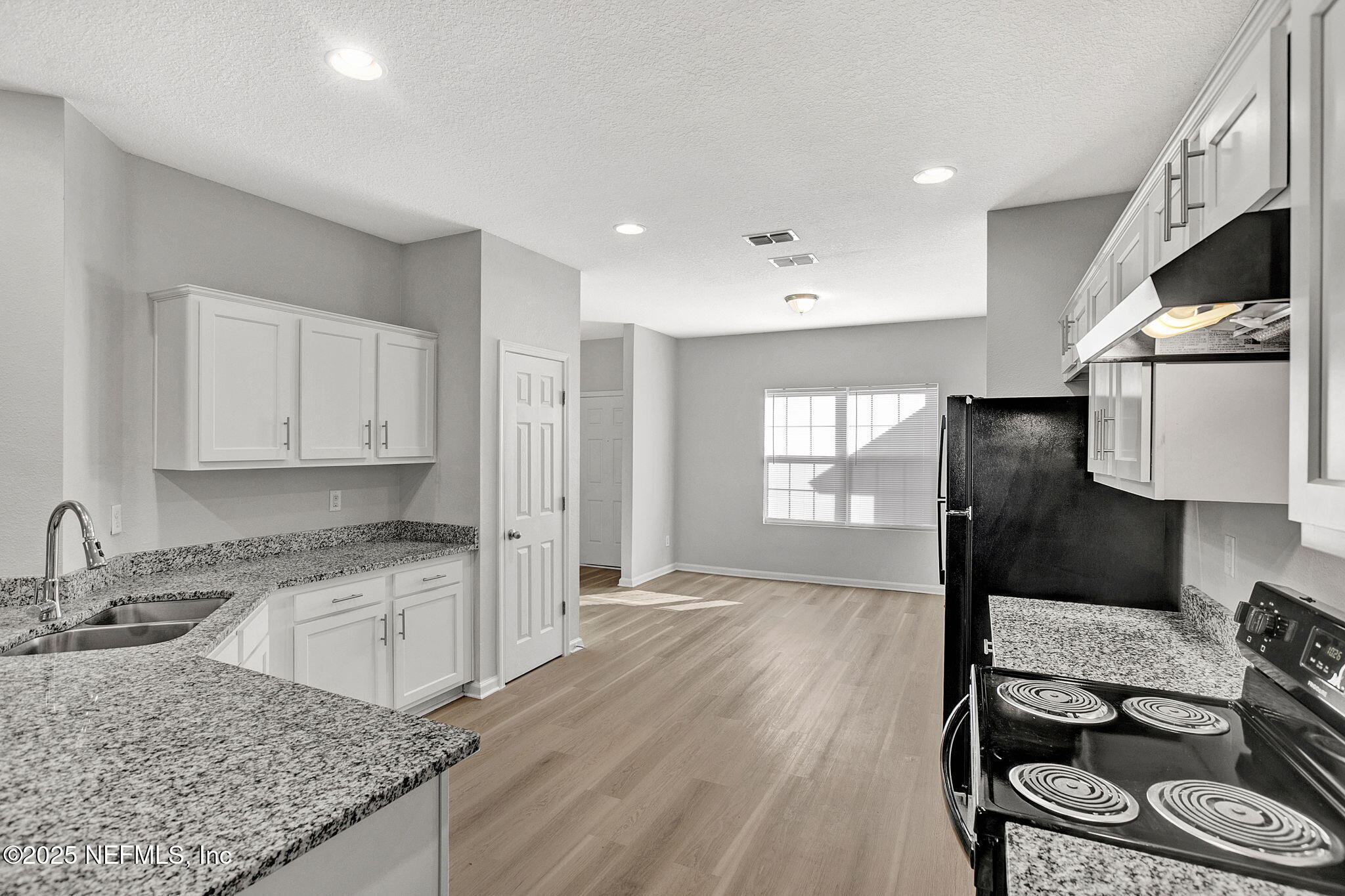 10632 Tulsa Road Jacksonville, FL 32218 - Photo 6 of 25 a kitchen with granite countertop a stove a sink and a refrigerator