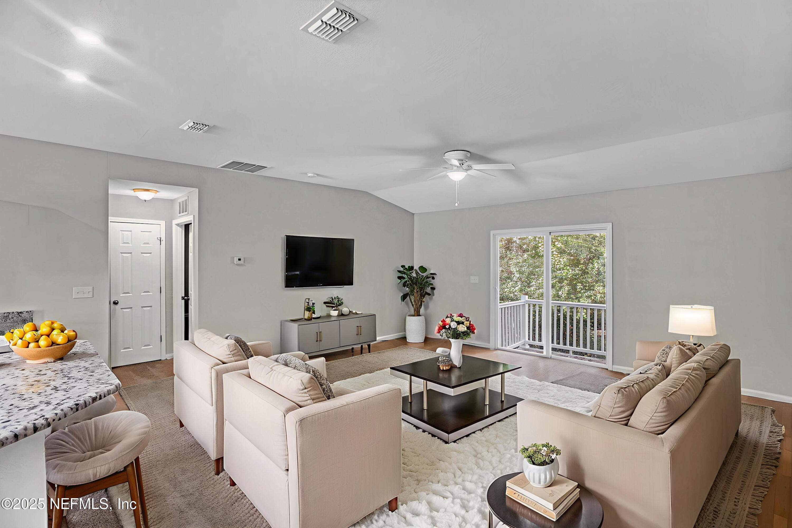 10632 Tulsa Road Jacksonville, FL 32218 - Photo 9 of 25 a living room with furniture and a flat screen tv