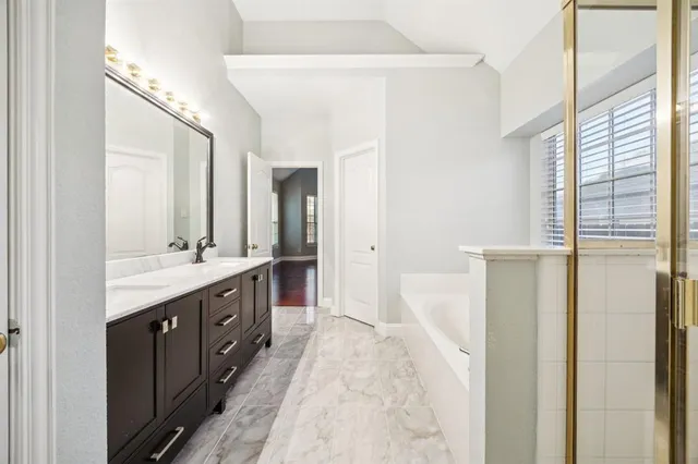 a spacious bathroom with a double vanity sink and mirror