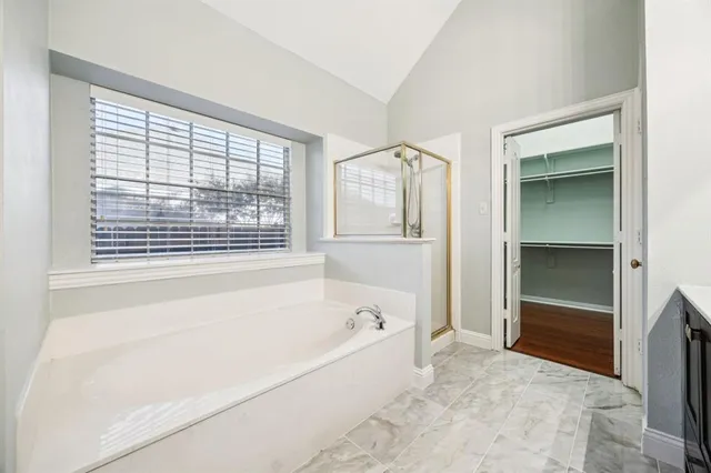 a bathroom with a bathtub and a shower