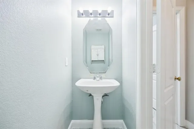 a bathroom with a sink a mirror and a shower