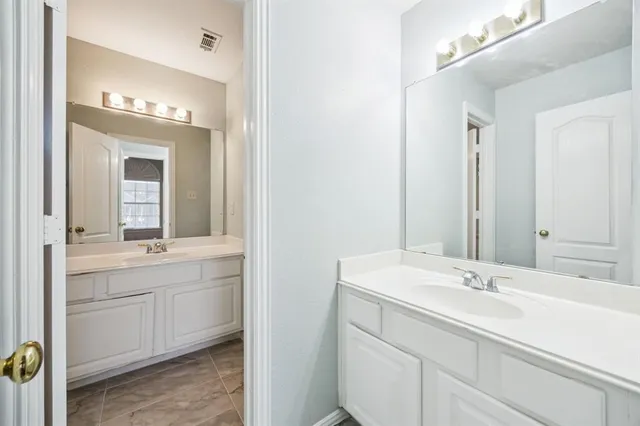 a bathroom with a sink double vanity and a mirror