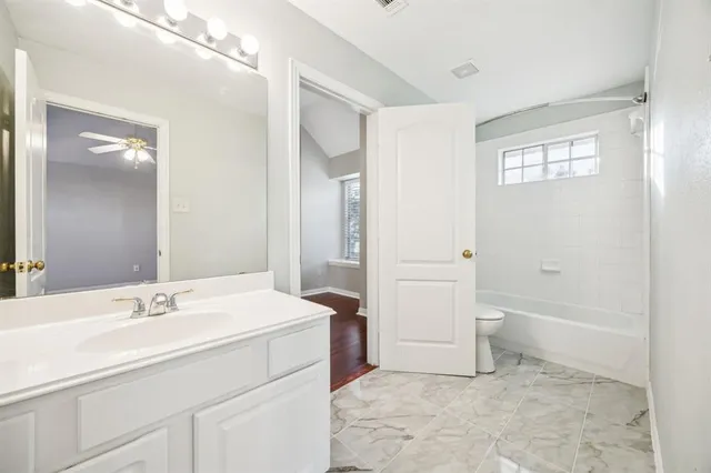 a bathroom with a sink a toilet and a bathtub