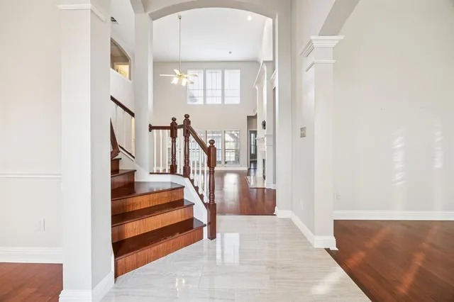 a view of entryway and hall with wooden floor