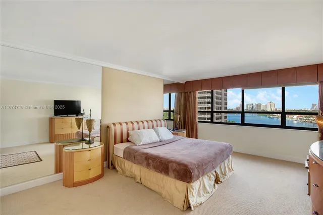 a bedroom with a bed and a large window