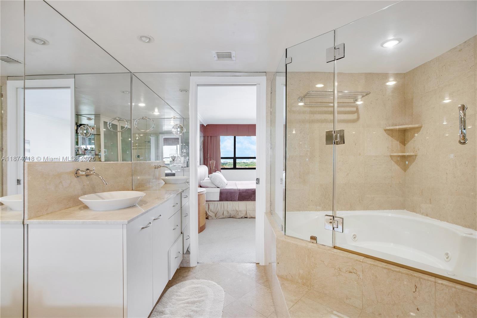 3 Grove Isle Drive, Unit C1108 Miami, FL 33133 - Photo 14 of 30 a spacious bathroom with a tub sink shower and mirror