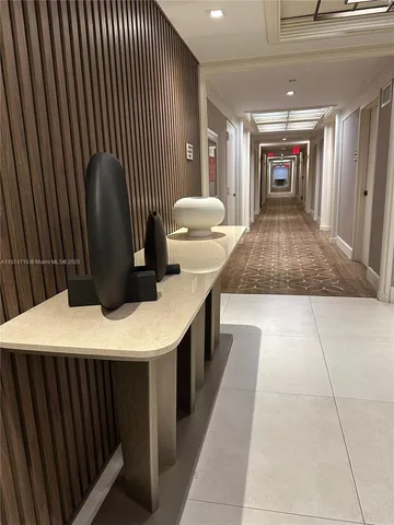 a kitchen with a sink window and chairs