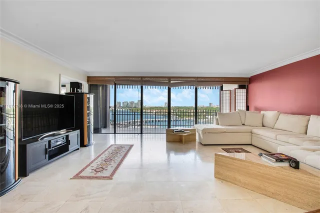 a living room with furniture a flat screen tv and a floor to ceiling window