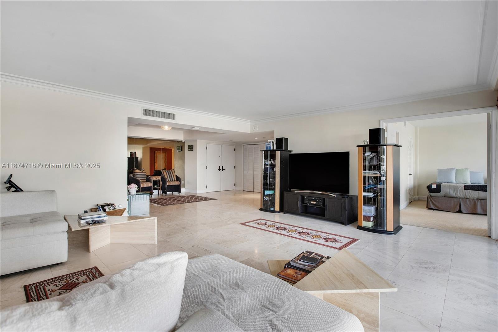 3 Grove Isle Drive, Unit C1108 Miami, FL 33133 - Photo 7 of 30 a living room with furniture and a flat screen tv