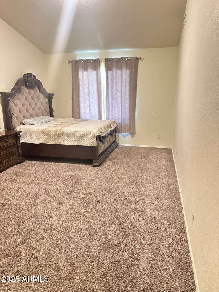 590 South Neely Street Gilbert, AZ 85233 - Photo 14 of 21 a spacious bedroom with a bed and a window