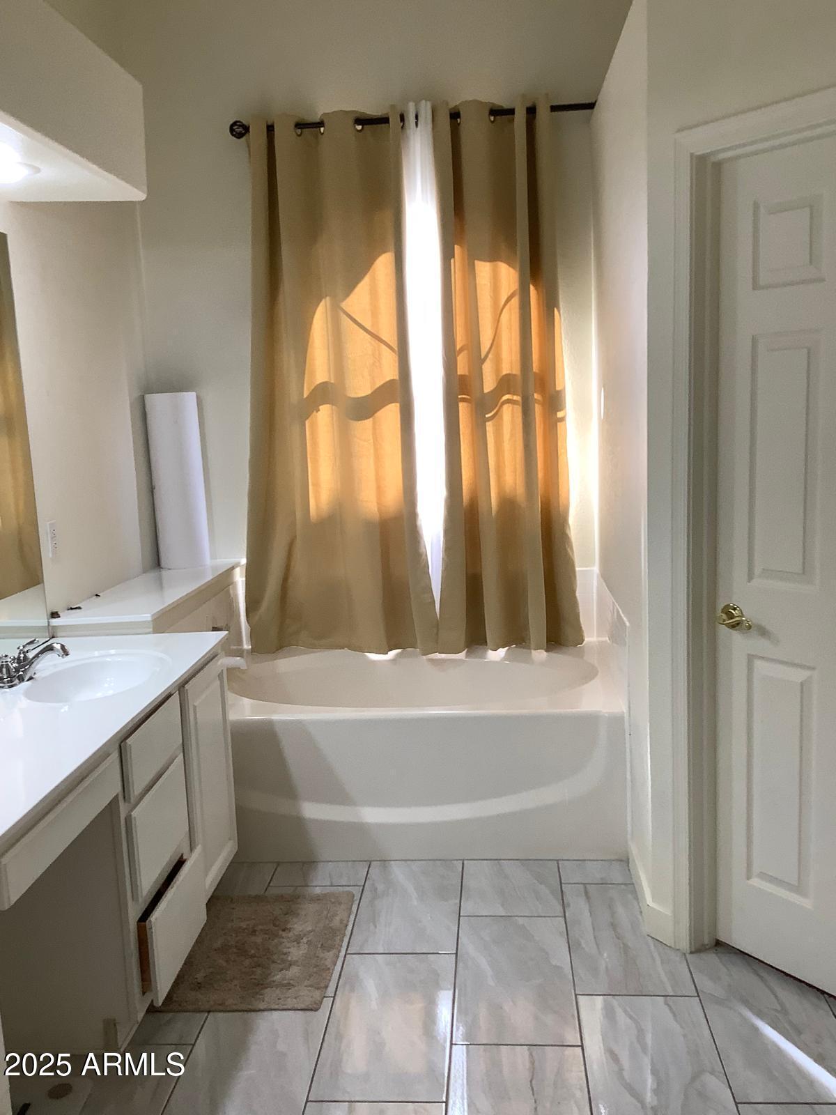 590 South Neely Street Gilbert, AZ 85233 - Photo 16 of 21 a bathroom with a granite countertop sink a toilet and a bathtub