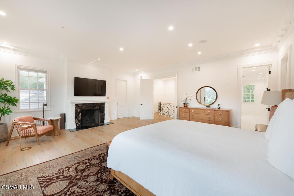 508 West Stafford Road Thousand Oaks, CA 91361 - Photo 25 of 35 a large bedroom with a bed a fireplace and a flat screen tv