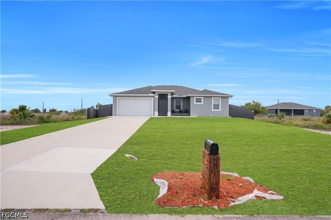 384 Neighborly Road LaBelle, FL 33935 - Photo 6 of 45 a front view of a house with a yard
