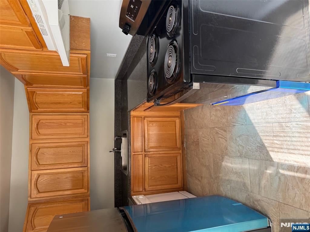 a kitchen with a stove and a white cabinets