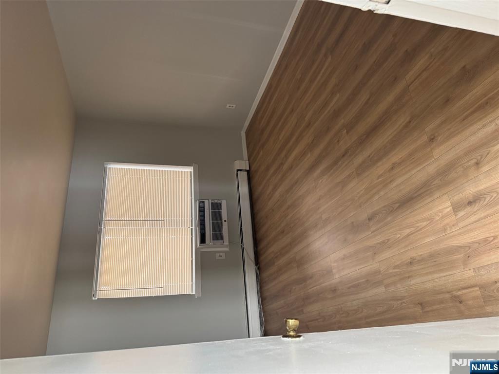 340 Hudson Street, Unit 44 Hackensack, NJ 07601 - Photo 3 of 8 an empty room with wooden floor and windows