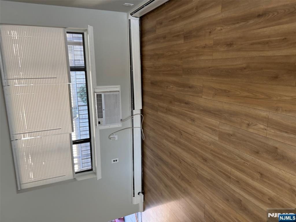 340 Hudson Street, Unit 44 Hackensack, NJ 07601 - Photo 6 of 8 a view of a room with wooden floor