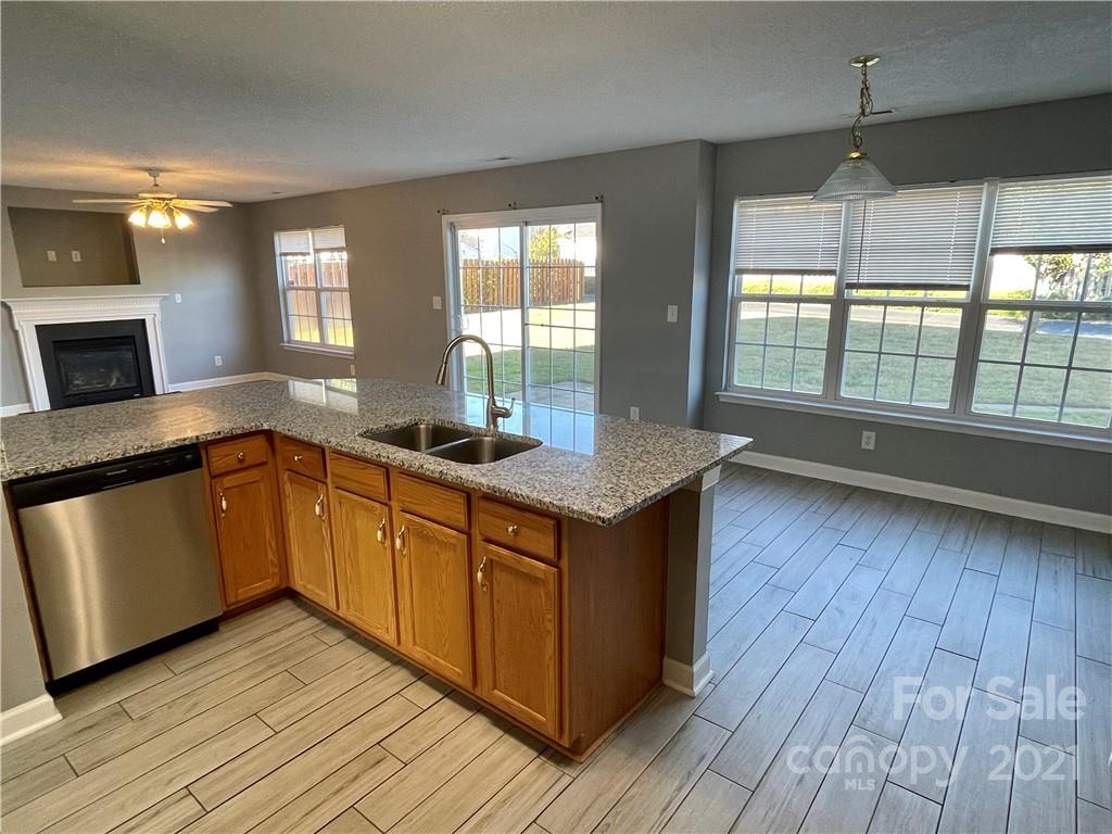 5514 Rogers Road Indian Trail, NC 28079 - Photo 14 of 34 a kitchen with granite countertop wooden floors and wide window