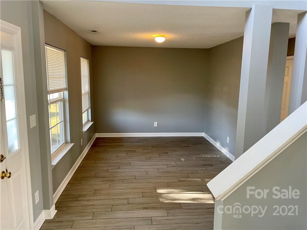 5514 Rogers Road Indian Trail, NC 28079 - Photo 3 of 34 a view of an empty room with wooden floor and a window