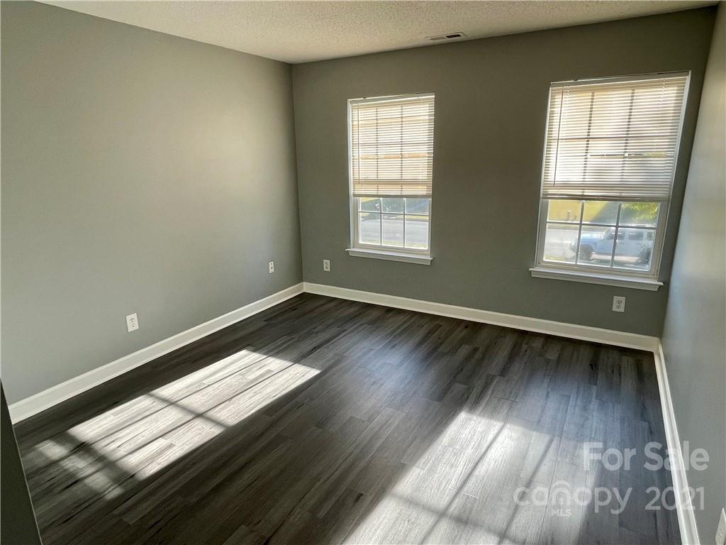5514 Rogers Road Indian Trail, NC 28079 - Photo 25 of 34 an empty room with wooden floor and windows
