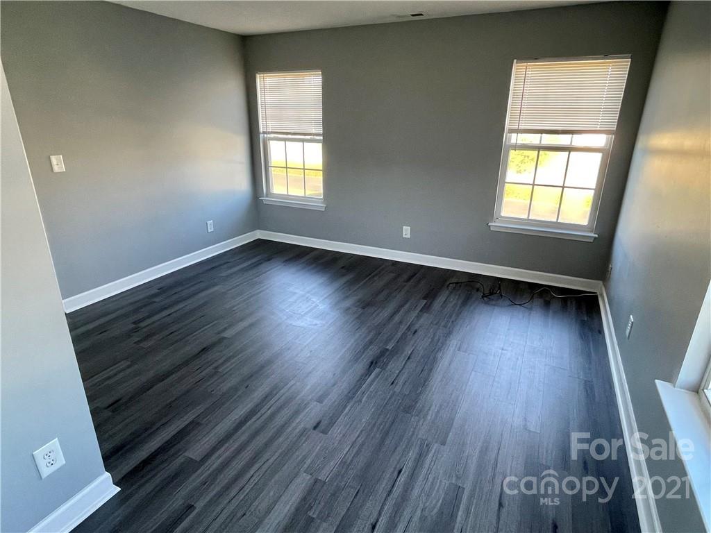 5514 Rogers Road Indian Trail, NC 28079 - Photo 30 of 34 an empty room with wooden floor and windows