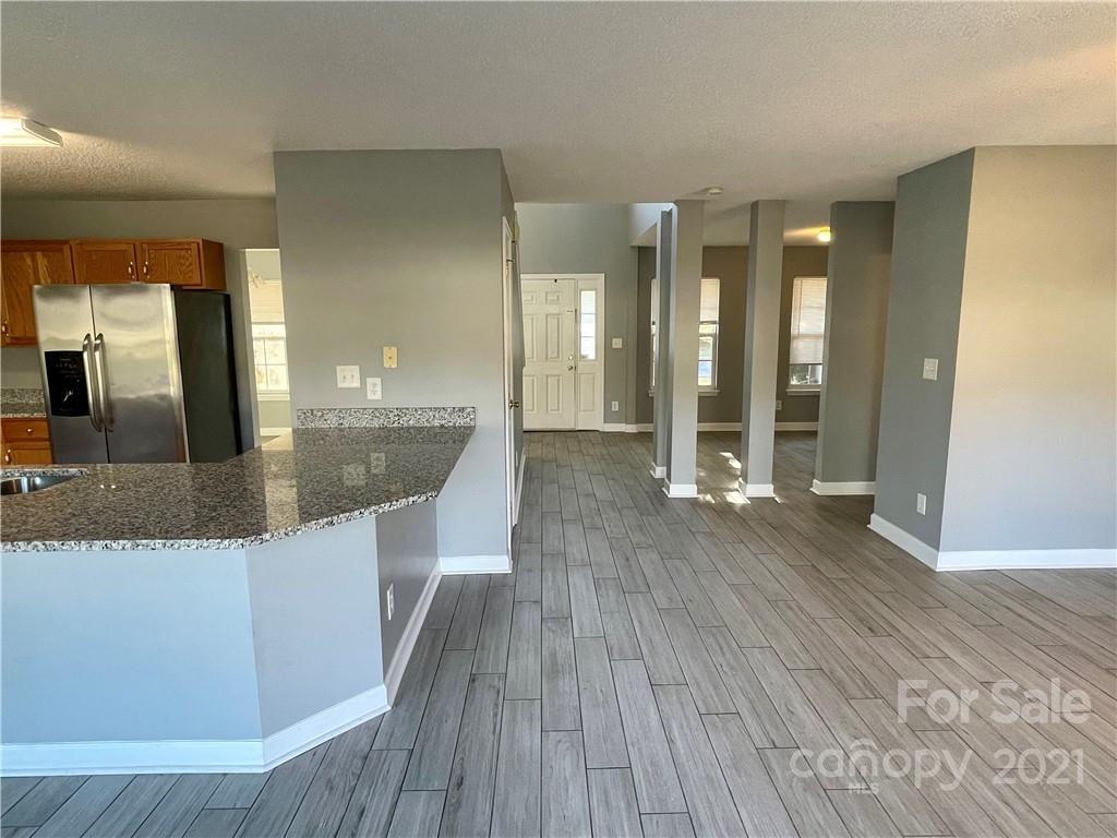 5514 Rogers Road Indian Trail, NC 28079 - Photo 10 of 34 a large kitchen with stainless steel appliances wooden floor and a large window