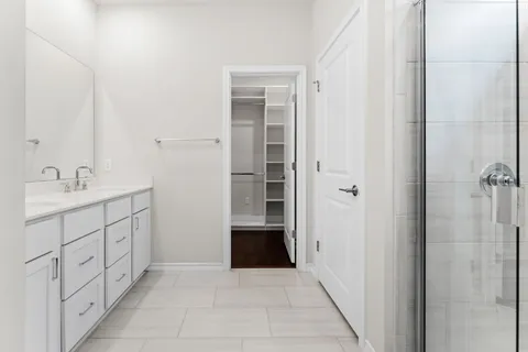 an empty room with wooden floor ceiling fan and windows