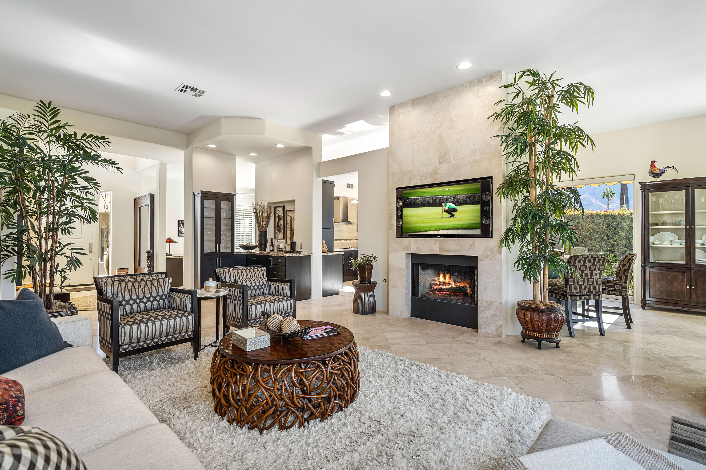 75762 Vista Del Rey Indian Wells, CA 92210 - Photo 11 of 49 a living room with furniture a fireplace and a chandelier