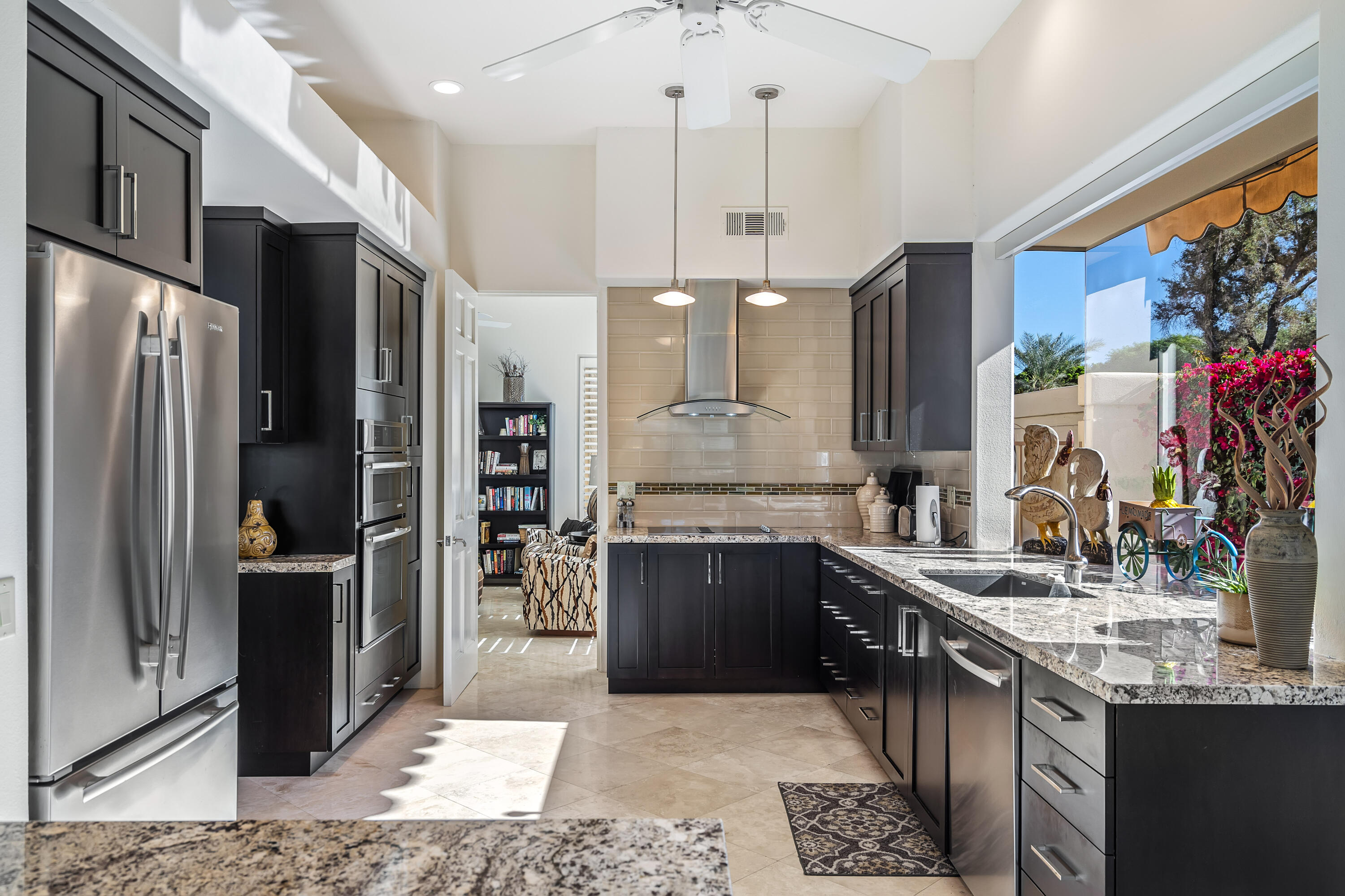75762 Vista Del Rey Indian Wells, CA 92210 - Photo 5 of 49 a kitchen with stainless steel appliances granite countertop a sink refrigerator and cabinets