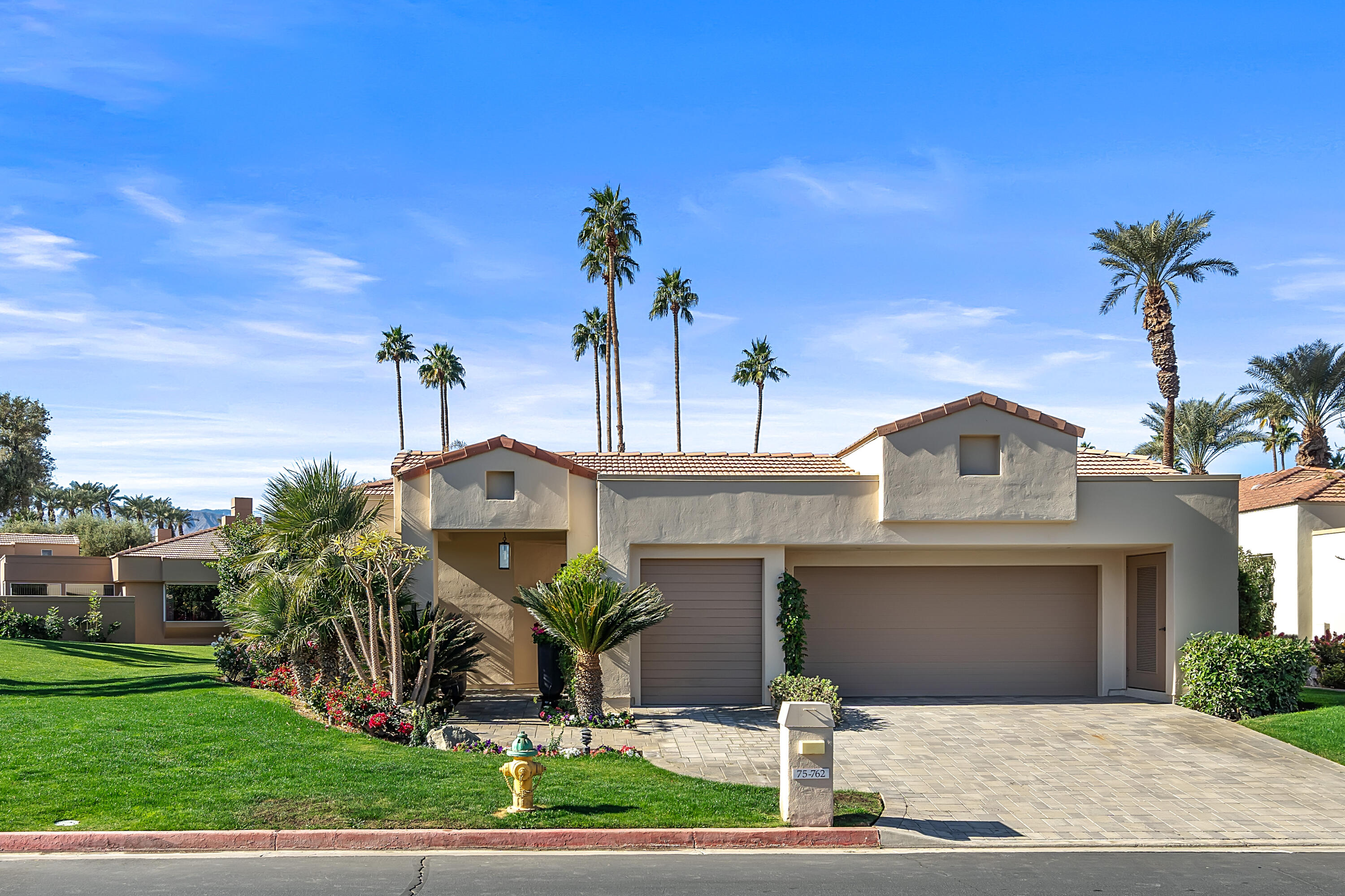 75762 Vista Del Rey Indian Wells, CA 92210 - Photo 6 of 49 a front view of a house with a garden and plants