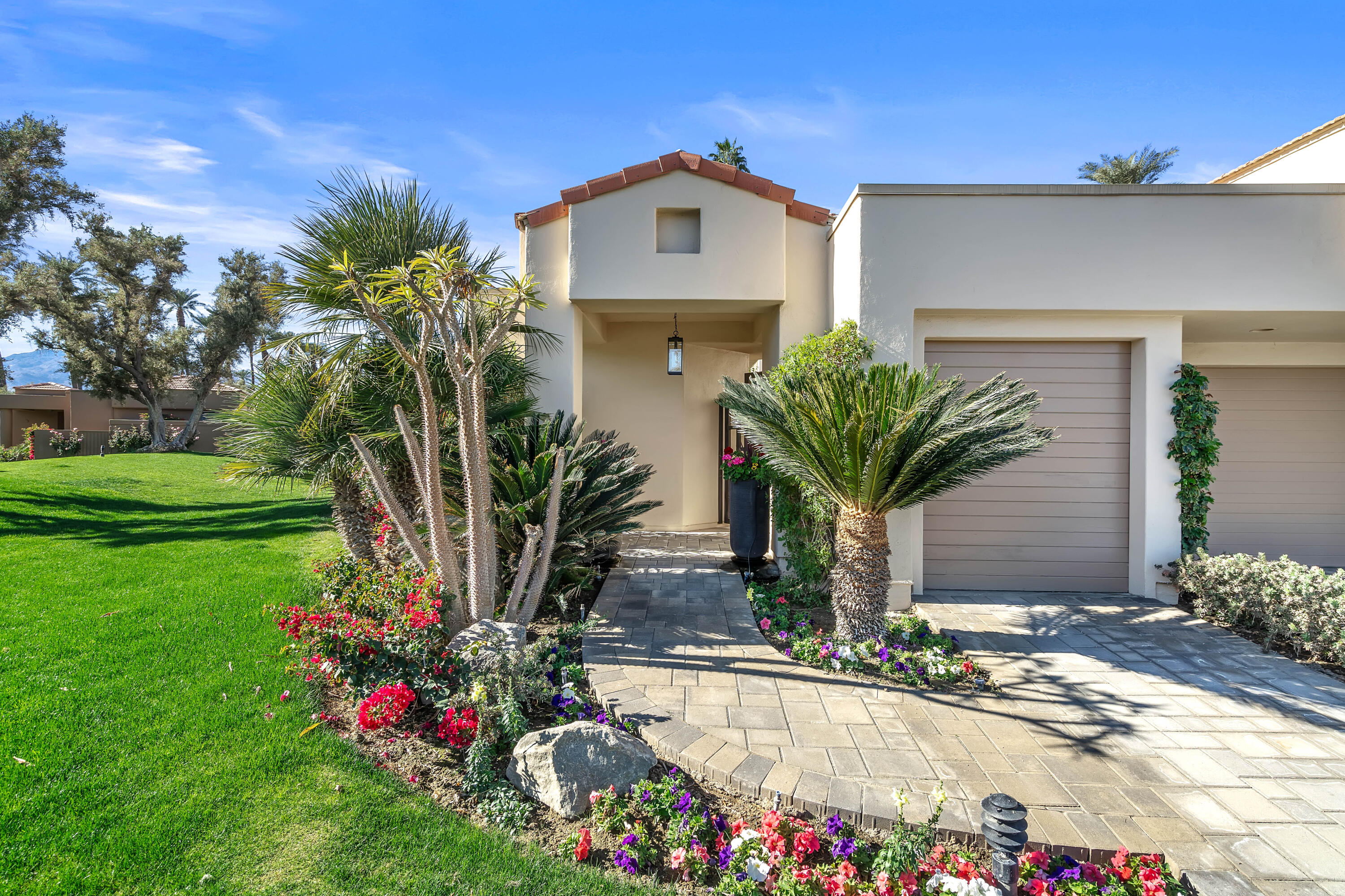 75762 Vista Del Rey Indian Wells, CA 92210 - Photo 7 of 49 a front view of a house with a yard