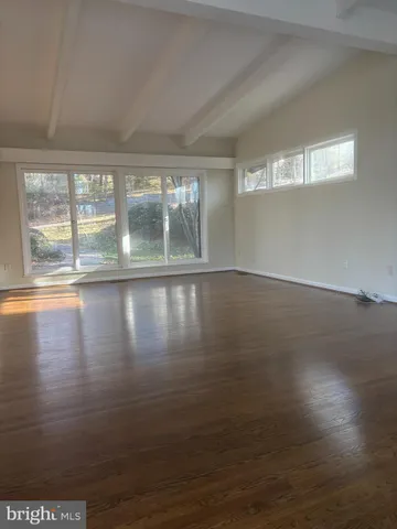 a kitchen with granite countertop white cabinets and a sink