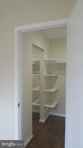 a bathroom with a granite countertop toilet sink and mirror