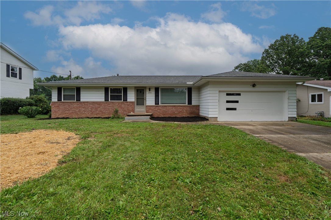 2783 Shellhart Road Barberton, OH 44203 - Photo 1 of 24 Single story home featuring a garage, driveway, brick siding, and a front yard