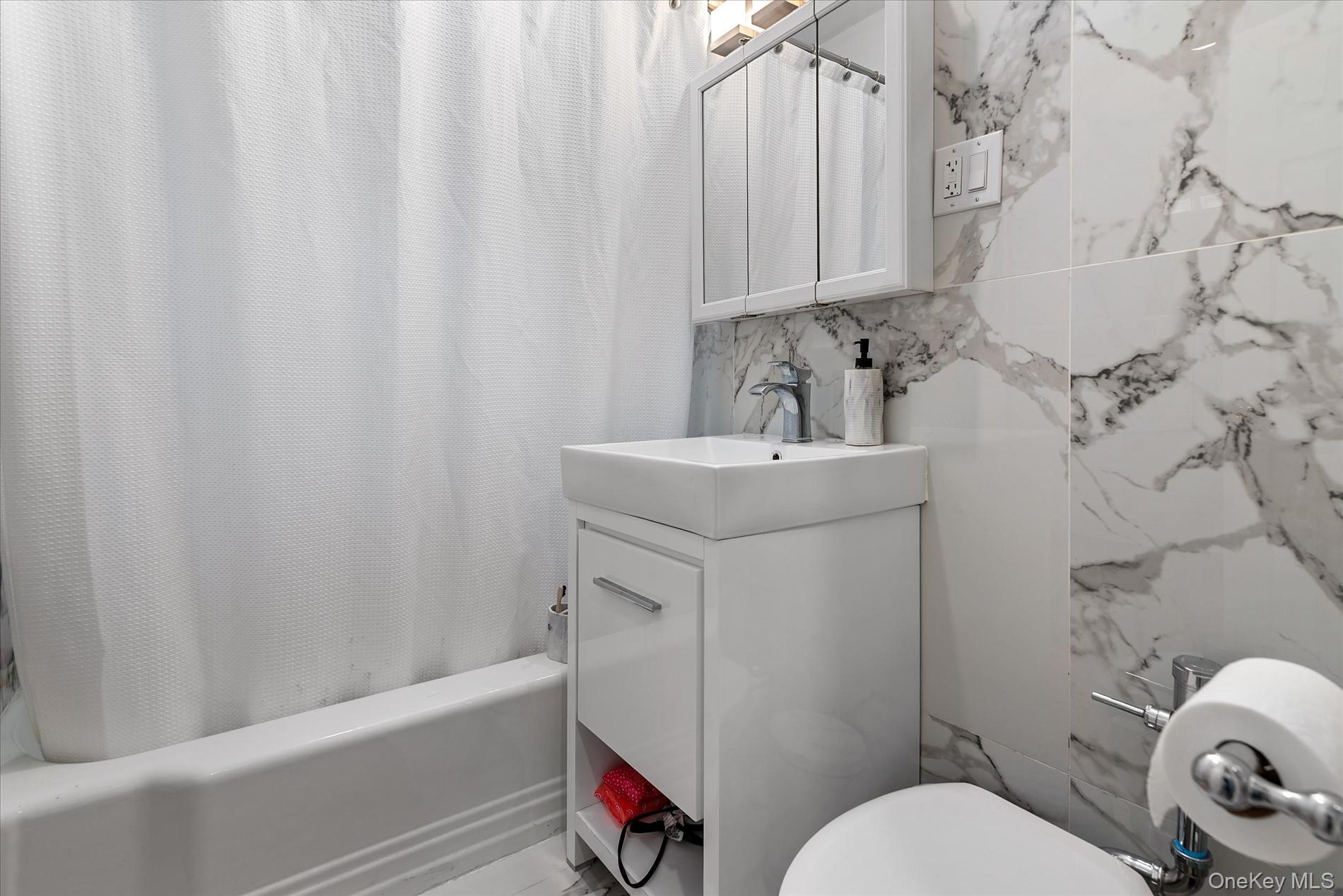 83-30 98th Street, Unit 5A Queens, NY 11421 - Photo 11 of 15 Full bathroom with shower / bath combo, vanity, toilet, and tile walls