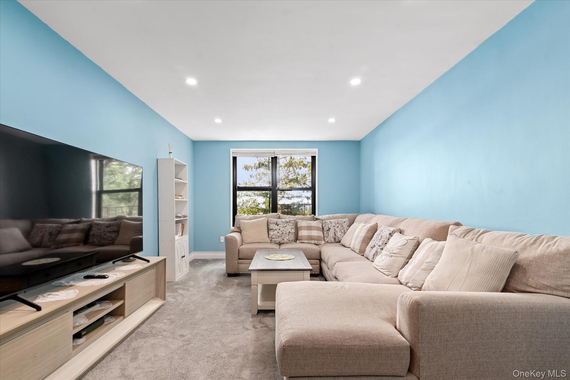 83-30 98th Street, Unit 5A Queens, NY 11421 - Photo 2 of 15 Living room with light colored carpet, recessed lighting, and baseboards