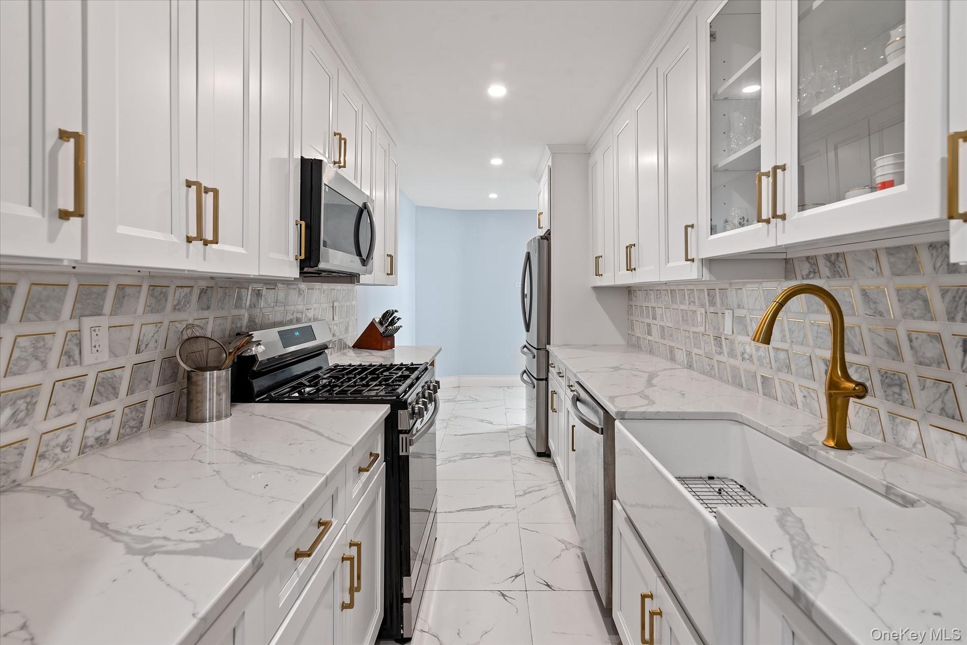83-30 98th Street, Unit 5A Queens, NY 11421 - Photo 6 of 15 Kitchen featuring stainless steel appliances, white cabinetry, recessed lighting, a sink, and backsplash